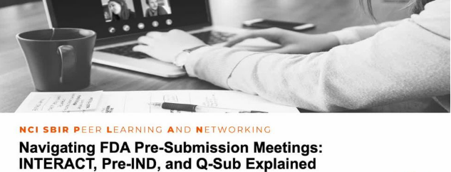 Black and white photo that depicts the arms and hands of a person on a laptop whose screen is showing a virtual meeting