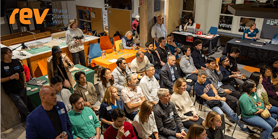 A room filled with people listening to a workshop