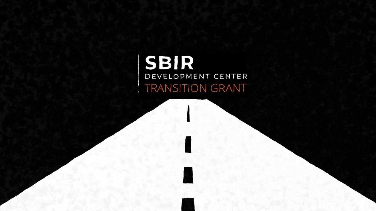 A white road against a black background with the words "SBIR Development Center Transition Grant" in all caps.