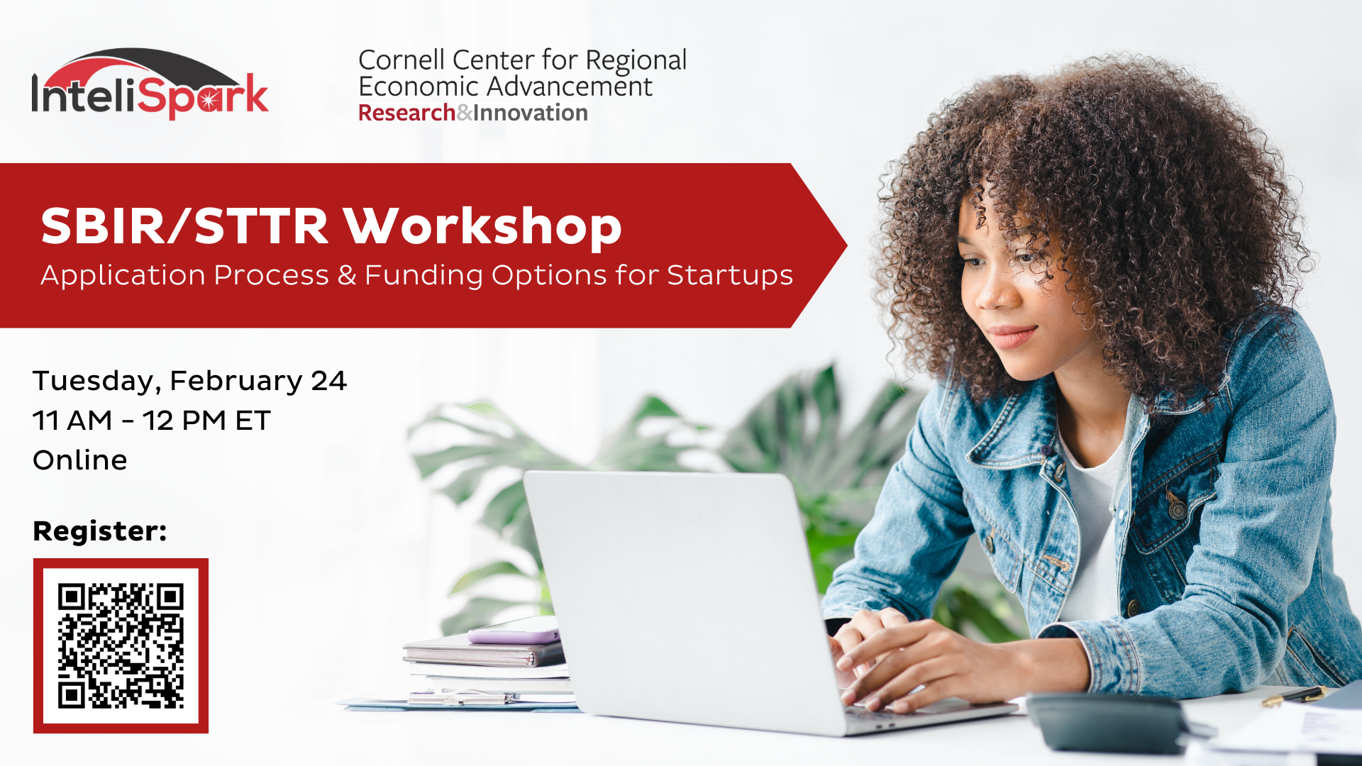 Young African-American woman wearing a denim coat looking at a laptop