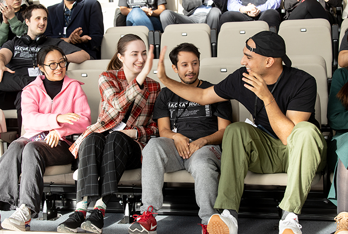A group of students celebrating after winning the $2000 prize during this year's Hackathon