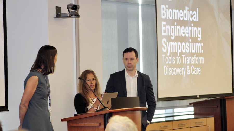 Symposium co-chairs, from left, Marjolein van der Meulen, director of the Meinig School of Biomedical Engineering; Dr. Susan C. Pannullo, director of neurosurgical radiosurgery and neuro-oncology at the Weill Cornell Medicine Brain and Spine Center; and Olivier Elemento, director of the Englander Institute for Precision Medicine. A man and two women standing at a podium.