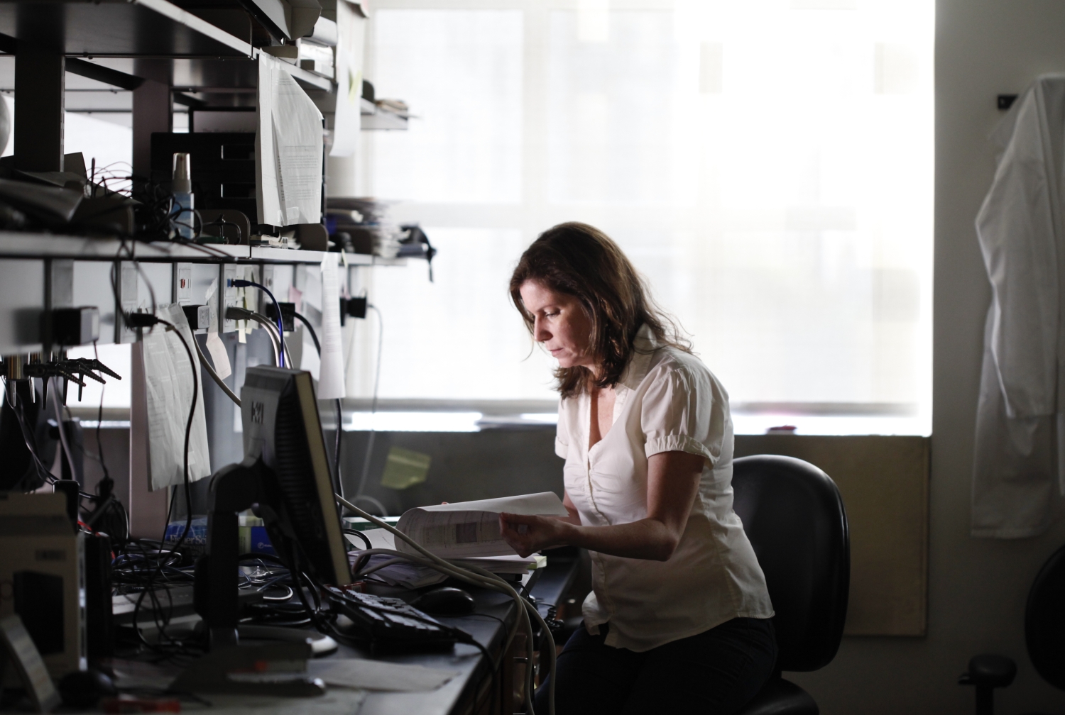 Woman sitting at desk and reading