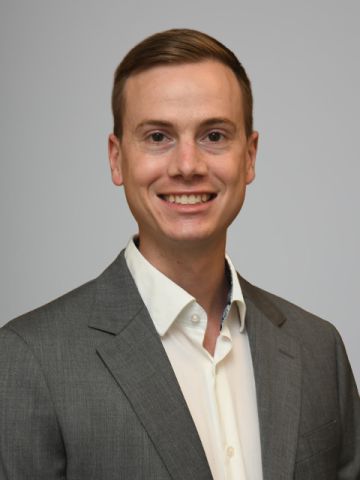 Young Caucasian man wearing a white shirt and gray suit