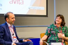Dr. Behzad Aghazadeh (Ph.D. '00) and Loren Busbay. Credit: Dag Bennstrom A man in a blue suit on the left and a woman in a green dress with pink flowers on the right talking on stage