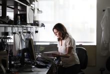 Woman sitting at desk and reading