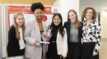 TammyCup team (from L to R) Angelina Fahrenkrug, Yaa Achampong, Yiwei Feng, Ana Grandgeorge and Dr. Tamatha B. Fenster of Weill Cornell Medicine. A group of five women of diverse ethnicities. An African-American woman in the middle holding a device prototype.