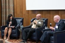 Three people sitting in chairs during a panel discussion