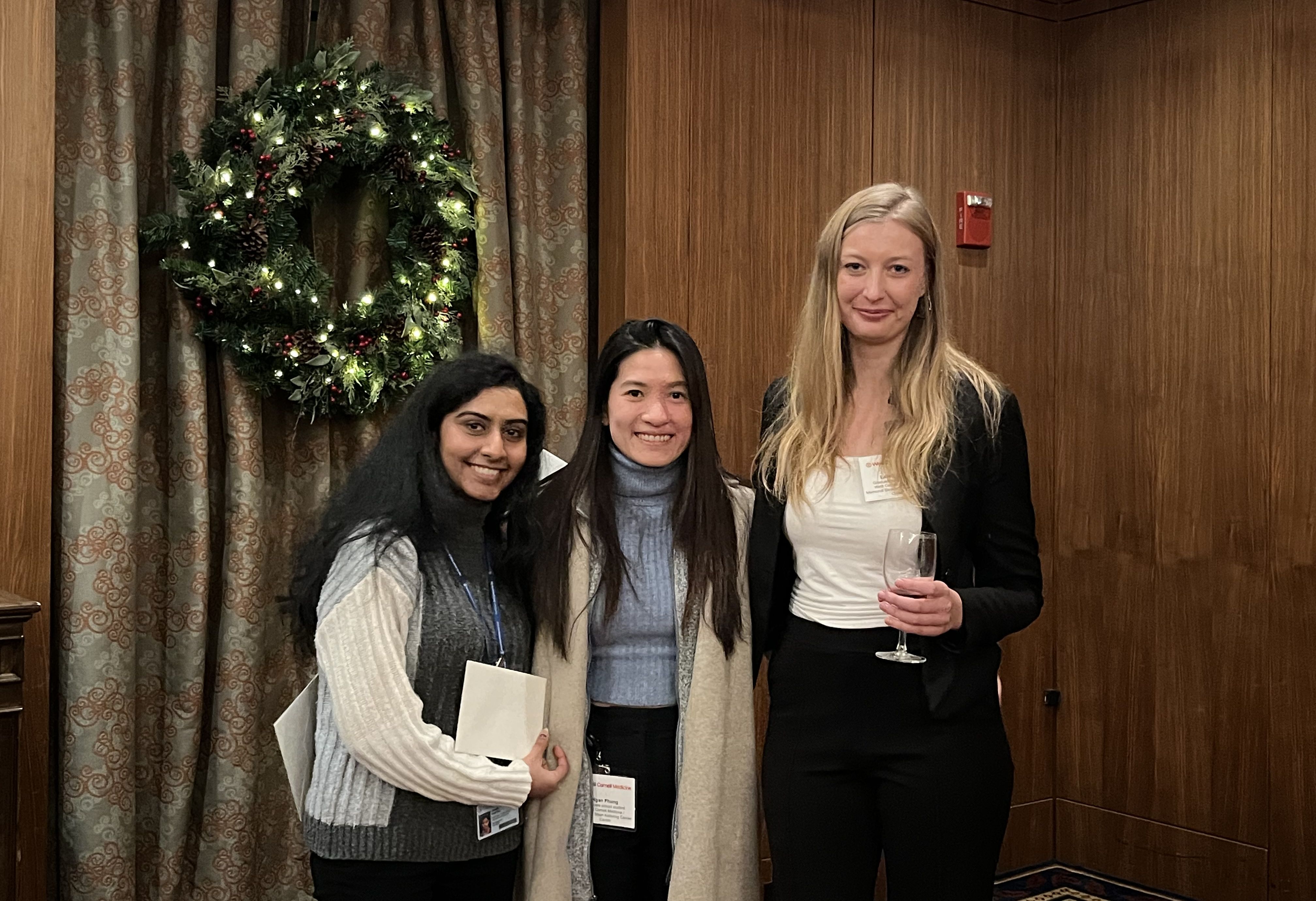 A team of three women smiling: two Asians and one Caucasian on the right