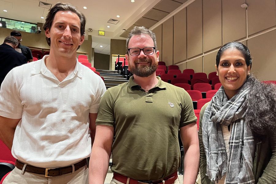 A group of two Caucasian men (left and center) and a South Asian woman.