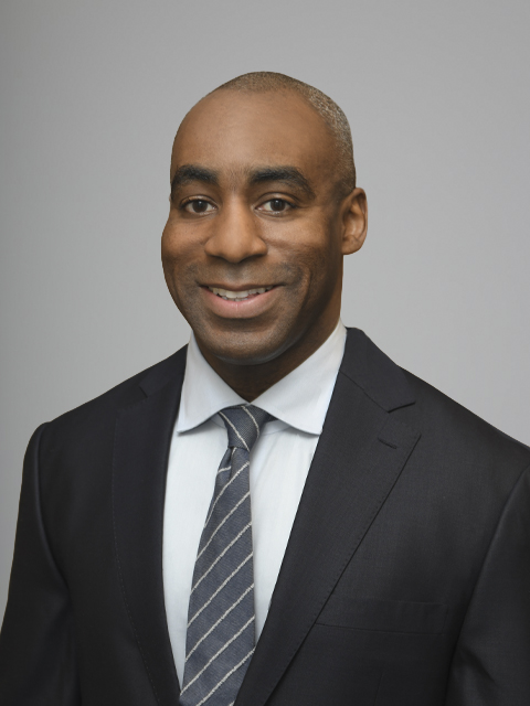 African-American man wearing a light gray tie and dark gray suit