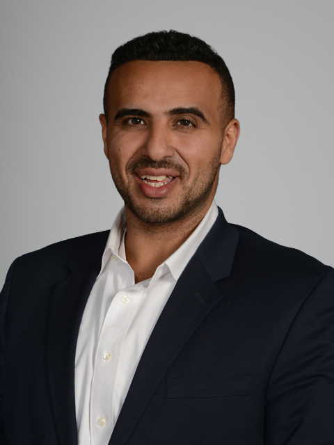 Middle Eastern man in white shirt and black suit